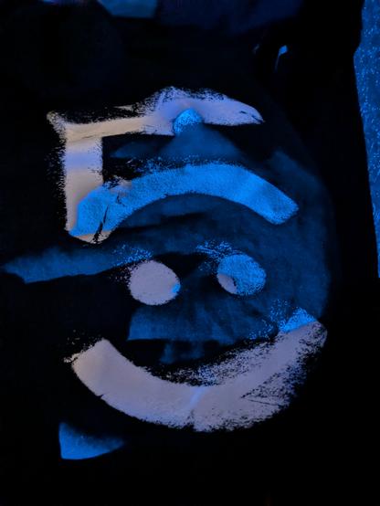 Back of a black awolnation Hoodie with the 5 album symbol in white