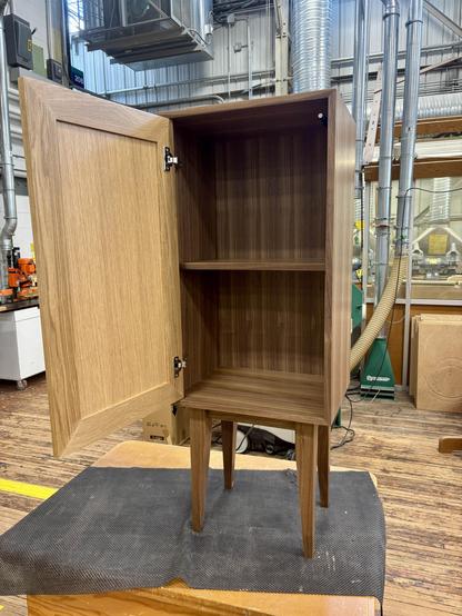 An inside look at the cabinet- it has a white oak interior panel to the door, and walnut interiors and shelf.