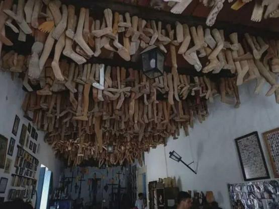 Ceiling with doll legs hanging from it.