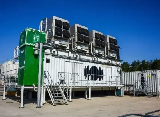 you see a containerized system with four big fans above. This assembly extracts CO2 from ambient air, concentrates it and binds into material for building. Carbonating the historic depth is mandatory.