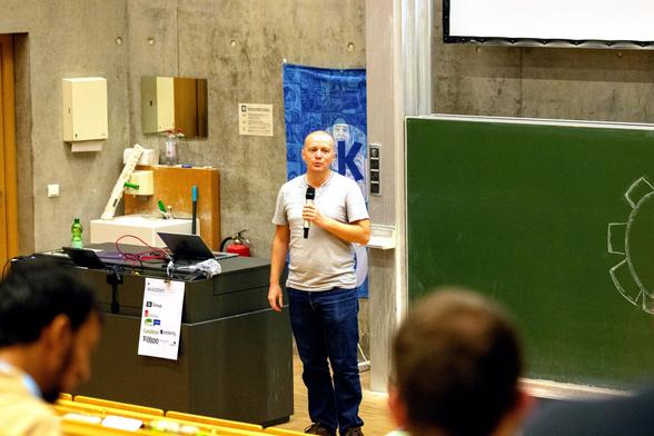 Picture from Akademy 2024 where the speaker is talking to the attendees