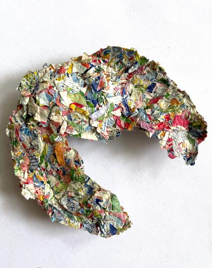Shredded and compressed fragment of what once was a stack of bank notes.