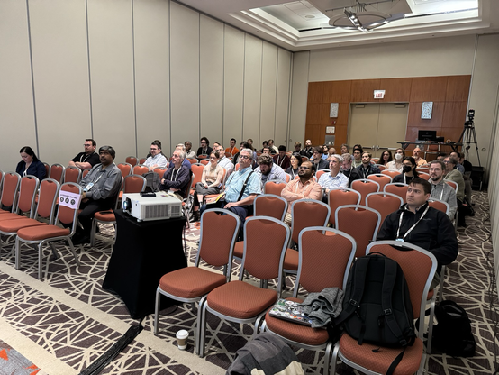 Audience intently observing Greg’s talk