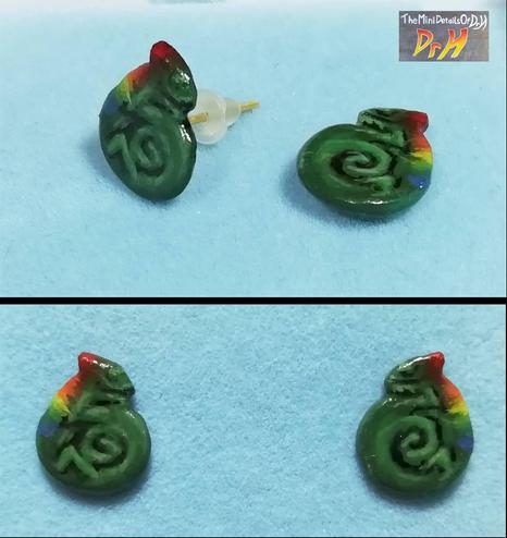 Pair of Chameleon earrings. Chameleon is curled up and has a rainbow down it's back. Various angles.