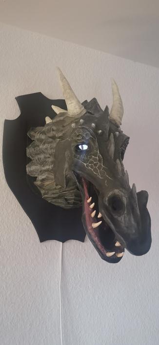 a dragon head made of papp maché with some uncanny eyes controlled ba an esp32 size about 50 cm, wall mount