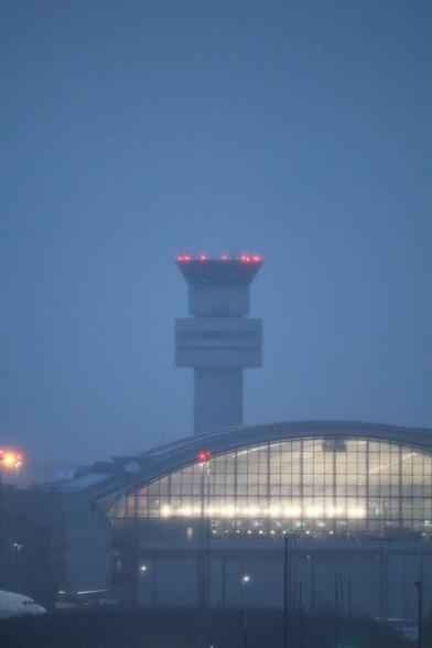Picture during rain and dusk of Pearson airport's main control tower.