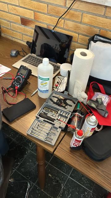 A workbench with multimeter and other tools.