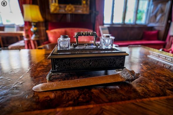 Ornate ink well on lacquered table