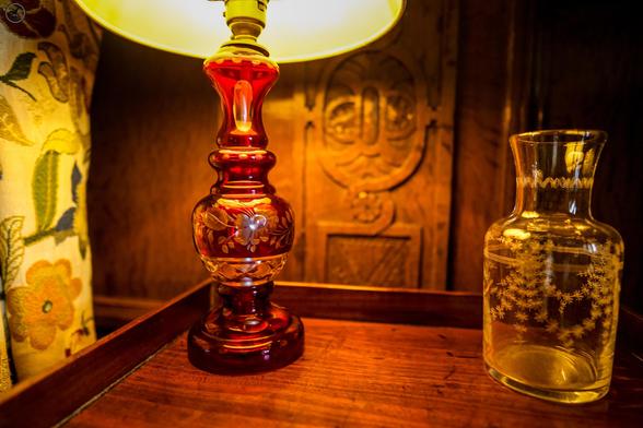 Ornate glass lamp and jar on table