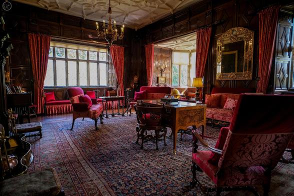 Period drawing room in reds and carved wood