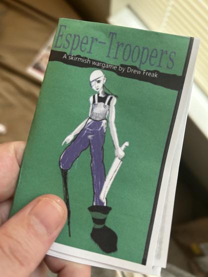 An image of an early prototype of the skirmish wargame esper troopers.

A psychic solder stand on the cover holding a machete like blade