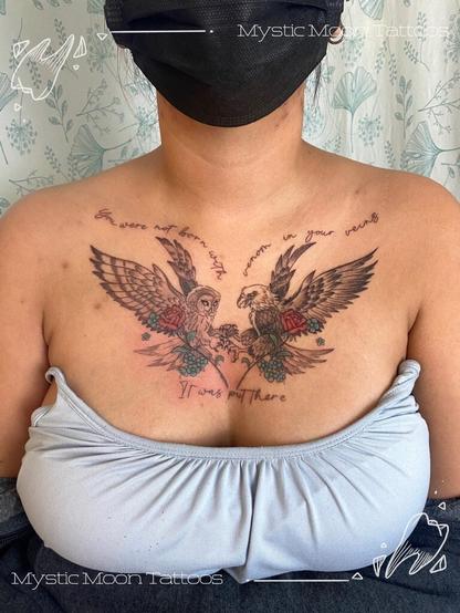 A chest tattoo depicting an owl and an eagle with locked talons, holding flowers, with script reading "You were not born with venom in your veins, it was put there"