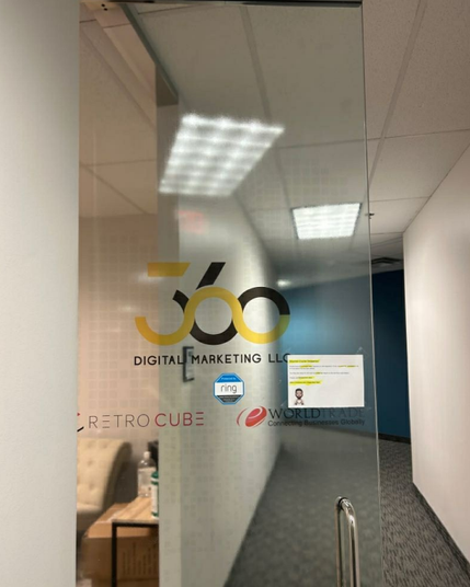 A photo of the front door at the Texas offices of eWorldTrade, 360 Digital Marketing LLC, and a related company called RetroCube. The latter two firms are connected to a vast network of sites selling ghostwriting, wikipedia editing, logo and website design services which have strong connections to entities and individuals in Pakistan that have been ripping people off.