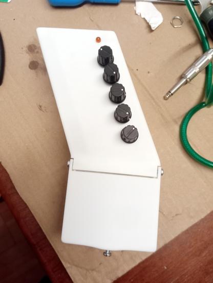 Guitar pedal with 5 knobs and main body angled at 22 degrees from the pedal