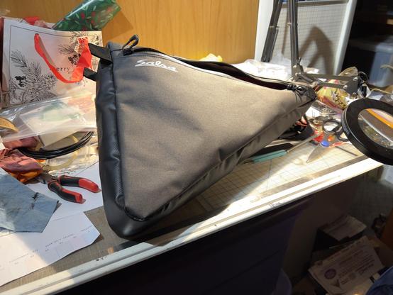 Image illustrating removal of straps on Salsa Triangle frame pack customization for internal mounting on my Marin Pine Mountain eTrail bike project build.