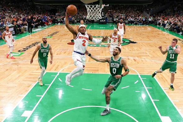 Miles McBride of the New York Knicks drives to the basket against Jayson Tatum in the Knicks