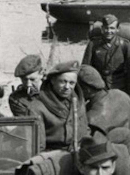 A zoomed-in crop of Bob Hearn. He's sitting on the back of a vehicle, looking directly at the camera with a half smile.