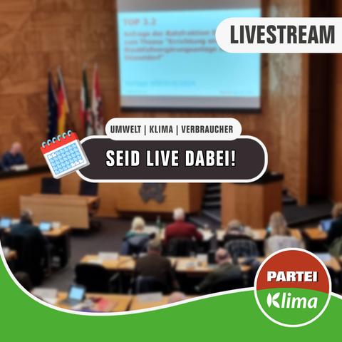 Zu sehen ist eine Totale des Plenarsaals unseres Düsseldorfer Rathauses. In einem weißen Kasten mit abgerundeten Ecken steht in anthrazitfarbener Sprache "Umwelt | Klima | Verbraucher". Darunter steht in einem anthrazitfarbenen Kasten mit weißen Buchstaben: „Seid LIVE dabei!"