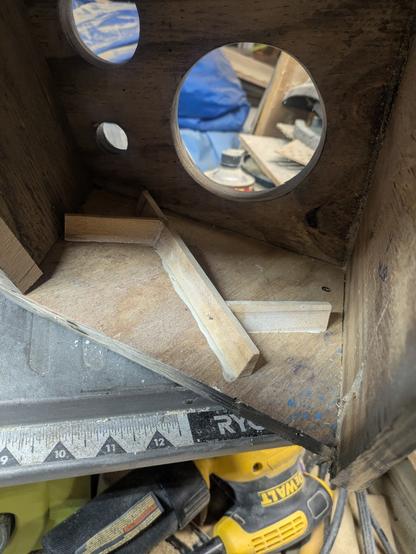 Inside one of the speaker boxes (see photo 4 alt-text); a herringbone-type brace is glued to the side.