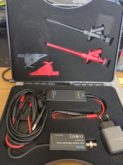 Interior of the case, showing the probe, cabling, USB-C adapter, high isolation alligator clips...