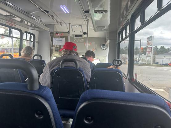 interior of the bus, with a standard interior of four rows of blue minibus seats.