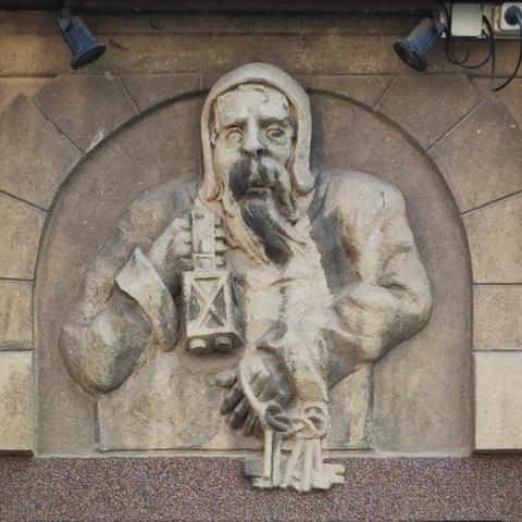 Bas-relief of a guardian with lamp and keys