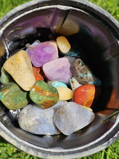 tumbled stones including amethyst and others in green and blue and purple tones.