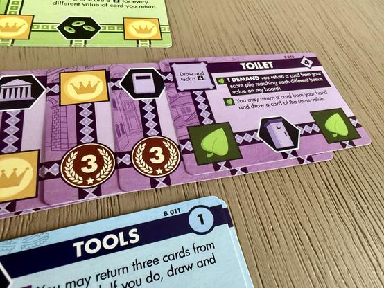 Innovation Ultimate (echoes of time expansion in play) Three colours of cards on display. The card “Toilet” is the top purple card.