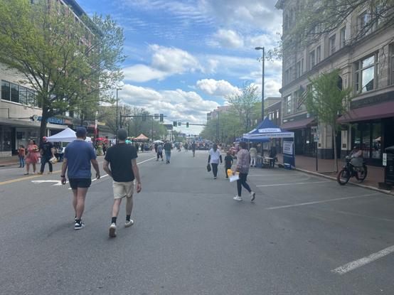 looking south on elm st, with stalls set up around. there is a good number of people walking about now.