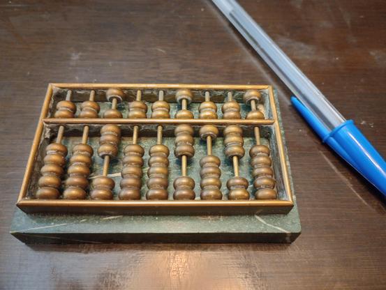 a miniature abacus with its beads shifted to form the number 8008135. the joke is that on a digital calculator, this would look like the word "boobies".