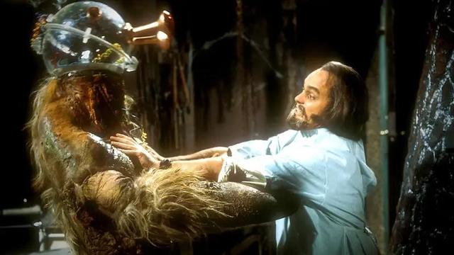 The Brain of Morbius in a plastic jar with protruding eye stalks sits atop a hairy body with a giant crab claw for an arm attacks the body’s creator, Doctor Solon, an absolute mad bastard.