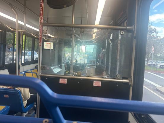 interior view of a very typical gillig. the seats are blue with hard yellow plastic.