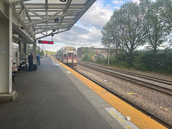 commuter rail train pulling into lawrence’s single track platform