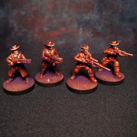 A set of 4 painted miniatures in red of sci-fi wild west style minis.
