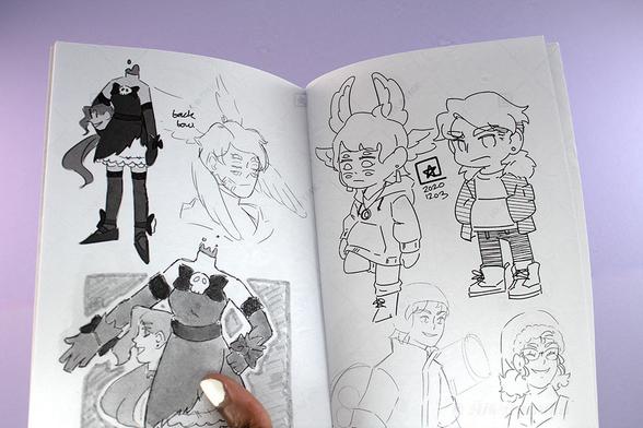 Open spread of the sketch zine,featuring sketches of various characters.