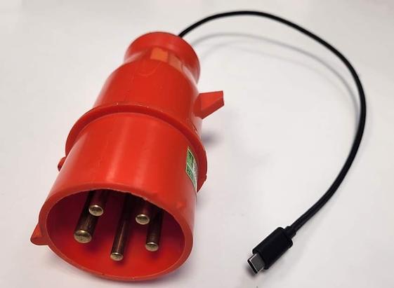 Cursed photo of a 3 phase power connector hooked up to USB-C connector.