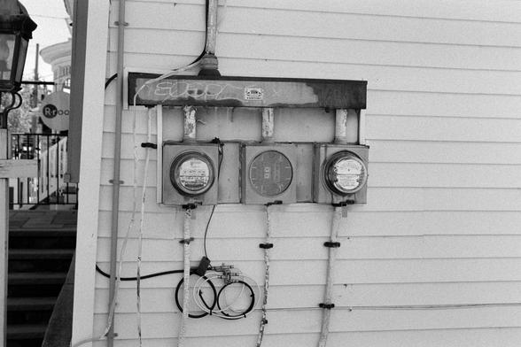A few electrical meters on the side of a house