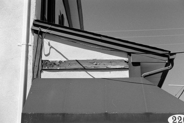 A weathered side of an overhang, with an additional awning below