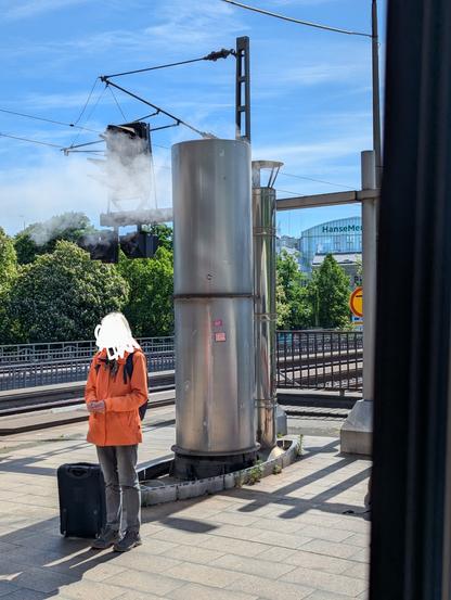 White smoke coming out of a chimney on a station platform
