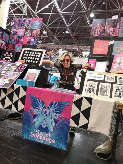 Picture of Sariel behind their booth at a convention last year.