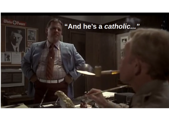 Frame from the movie "The Blues Brothers": the head of the Illinois Nazis receives a report about the owner of the Bluesmobile, Elwood Blues. The goon ends his report with a sneer of disdain while saying "and he's a catholic..."