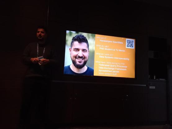 Harry's self-introductory slide. There's a QR code there