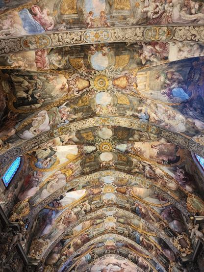 wide-angle shot of very intricate fresco on vaulted ceiling of a church. in style and subject matter it very much resembles the Sistine Chapel.