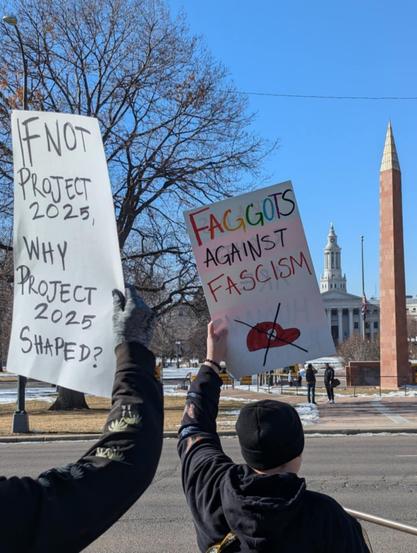 a protest sign that says
if not project 2025, why project 2025 shaped?
