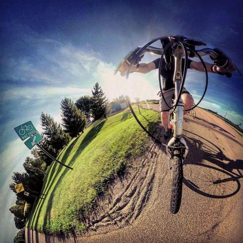 One of a series of photographs showing people biking on a bicycle trail near Mankato, Minn., in summertime.