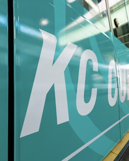 Close up of the side of our streetcar wrap where it says “KC”