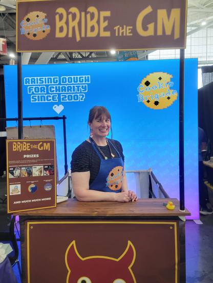 A cookie brigade volunteer at a bribe the gm stand