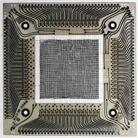 A central square grid of small rings strung up on thin wires in a square hole, surrounded on all sides by a square frame where the thin wires terminate in thicker traces that radiate outward.