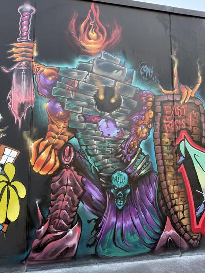 Graffiti of a wall, with eyes, arms, a clock, and a belt. In the right arm is a broken sword, in the left arm is a shield with the text "exist to resist". The clock shows a minute before midnight. The belt says "the wall".