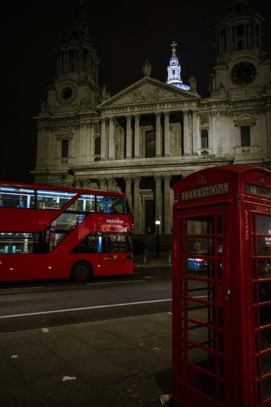 Night shot of illuminated St Paul's Cathedral with a red London bus and telephone box in the foreground
Captured by Komeil Karimi